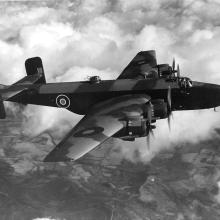 Handley Page Halifax in flight with clouds and the Earth in the background