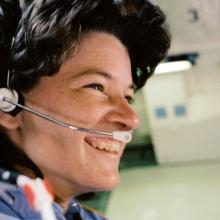 Sally Ride in astronaut flight suit and headset 