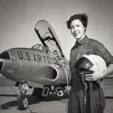 Wally Funk standing with a U.S. Air Force jet.