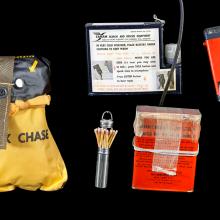 A composite image showing matches, a radio, strobe lights, and a shark chaser against a black background. 