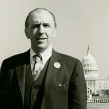 A man with a briefcase in front of the Capital.