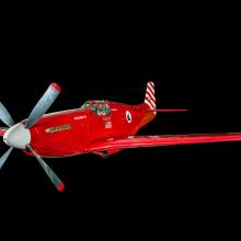 View of a red and white plane. Painted below the cockpit is the American flag.