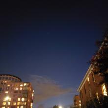 A photo of the night's sky in DC between two buildings.