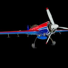 Red and blue painted plane. From this angle, you can see the propellers, landing gear, and fuselage of the plane. 