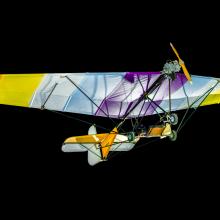 View of a undercarriage of a glider. The background of the image is black.