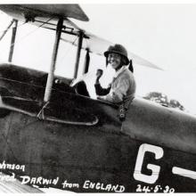 A woman in the flight deck of an airplane.