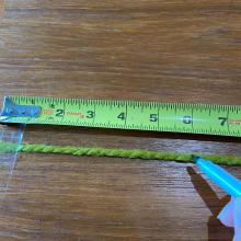 A string stretched against a measuring tape.