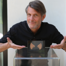 Man in black shirt points to Spock ears in a box