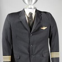 A photo of a male pilot's uniform on a mannequin. 