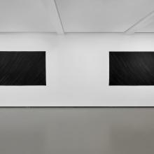 Two works of art with the same dimensions displayed on a white wall in a gallery.