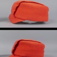 Orange flight attendant hat compared side by side with different viewing angles. Both photographed against a white-grey backdrop.