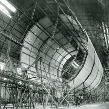 The framework of an airship. Half of the frame is covered in material.