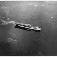 Black and white grainy image of USS Langley in ocean