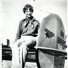 Amelia Earhart seated on the horizontal stabilizer of her Lockheed Model 10-E Electra