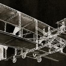 Model of a Wright-type biplane against a black background.