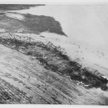 A aerial view of a crash site of a larger aircraft.