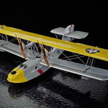 A grey biplane with two propellers with yellow details. 