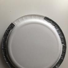 Two plates facing each other taped together with duct tape. 