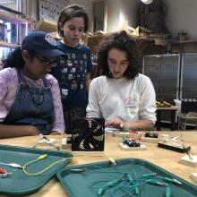 Campers at the S.H.E. Can STEAM Aviation Camp work on circuits