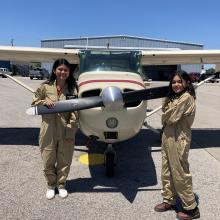 Participants in the S.H.E. Can STEAM Aviation Camp pose in front of an airplane