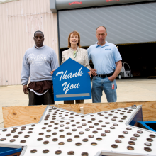 Three Smithsonian staffers stand by the Astroland star holding the "thank you" sign.