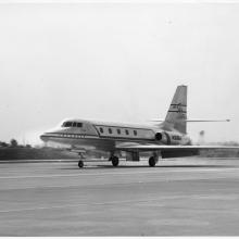 A mid-sized jet airplane landing on the runway.