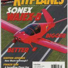 A magazine cover with a small red monoplane flying across. Headlines on the cover include ignition advice and group fly-outs.