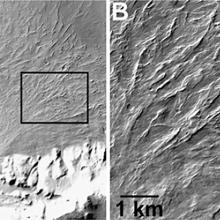 Two topographical images, the one on the left is labeled "A" with a smooth area at the center of a curve. On the right, is a bumpy topographical image.