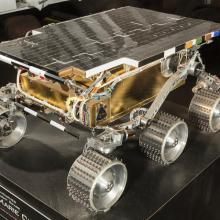 A four wheel Mars rover with a flat top. 