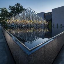 A statue in a water feature stands in front of the National Air and Space Museum.