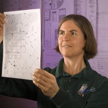 A woman looks at a read out. 