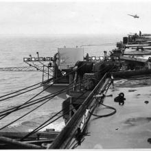 Black and white image of a mirror landing system (MLS) seen on the edge of an aircraft carrier