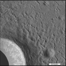 Small ridges surround the outside of a crater on the Moon.