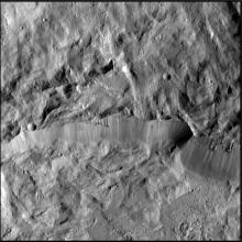 An image with the rim of a crater running through its center horizontally.