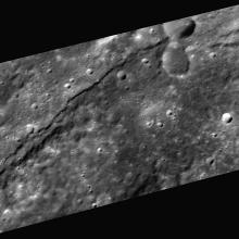 A scarp, or steep cliff, extends horizontally through this image of Mercury's surface.