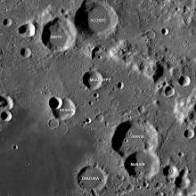 An image of craters on the Moon labeled with the names of the lost crew of Space Shuttle Challenger. From the top of the image to the bottom they are Scobee, Smith, McAuliffe, Resnik, Jarvis, McNair, and Onizuka.