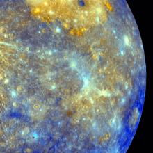 An image showing a half circle view of Mercury's surface in purples and yellows. 