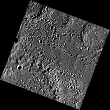 An image of Mercury's surface dotted with craters.