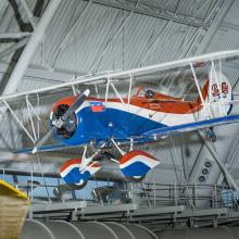 Red white and blue biplane with Pepsi-Cola logo on the back