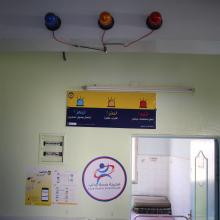 Three warining lights in various colora are attached to the walls in a facility.