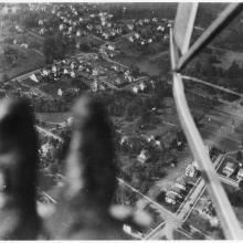 A photo taken looking down at Earth. Blurry boots can be seen in the corner of the frame. 