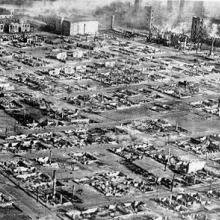 An aerial photo of a cityscape that has been razed almost entirely to the ground. 