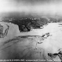 An aerial photo of the coast of the Potomac River, which has overflowed onto the land and covered some structures.