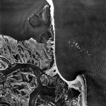 An aerial photograph of swooping coastline.