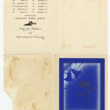 Unfolded card. Upper left corner contains upside down text with the Pan American Airways Logo. Bottom left corner contains a blue silhouette of bells and gold cursive text, "Happy New Year."