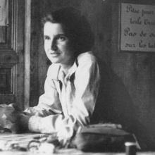 Rosalind Franklin sits at a table