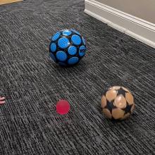 Three balls sit in a hallway.