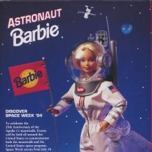 The back of the box that 1994 Astronaut Barbie was sold in. It depicts Barbie walking on the Moon while wearing a white spacesuit and planting a Barbie flag into the ground.