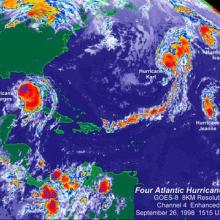 A meteorological satellite image of four hurricanes all within proximity of each other. Georges is the farthest left, near the Gulf of Mexico; followed by Karl, Ivan, and Jeanne to the right, further into the Atlantic Ocean. 