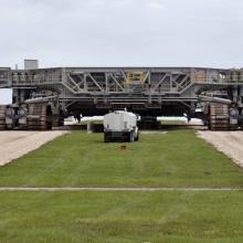 Giant mobile launch crawler on roadway.